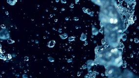 Slow Motion Shot of Water Splash. Macro water drops Professional video of blue  water bubbles 