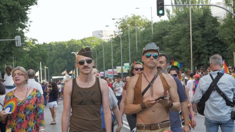 Madrid, Spain. CIRCA July 2019: Crowd of people in a Gay Pride LGTB demonstration in Madrid. Disguised men cowboy and marine