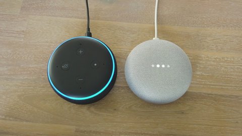 Amazon Alexa Echo Dot 3 and Google Home Mini - Two different Mini Smart Home Voice Assistant Controlled Gadget Responding To Command