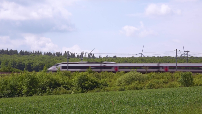 NORMANDY, FRANCE - CIRCA 2018 - A high speed electric passenger train passes through the countryside of Normandy, France.