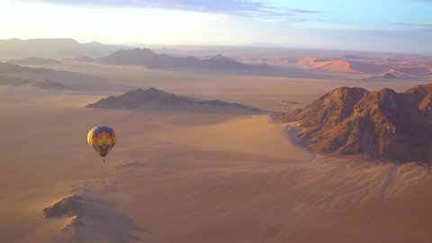 NAMIBIA - CIRCA 2018 - Hot air balloons fly in the Namib desert in Namibia.