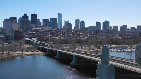 BOSTON, MASSACHUSETTS - CIRCA 2018 - Aerial establishing city skyline of Boston Massachusetts with Longfellow bridge and subway train crossing.