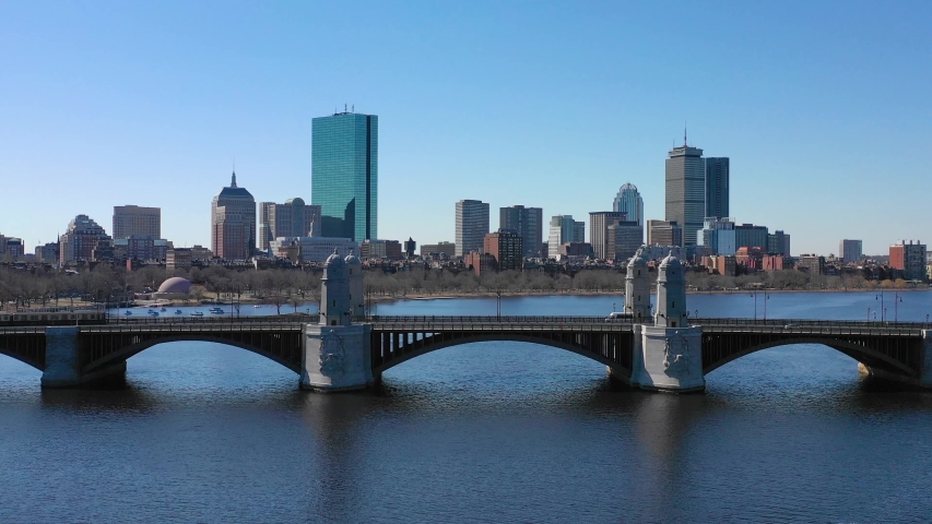 BOSTON, MASSACHUSETTS - CIRCA 2018 - Aerial establishing city skyline of Boston Massachusetts with Longfellow bridge and subway train crossing.