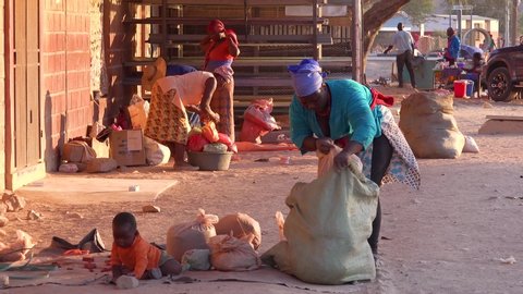 OPUWO, NAMIBIA - CIRCA 2018 - Poor African citizens shop in a basic Africa street market in Opuwo, Namibia.