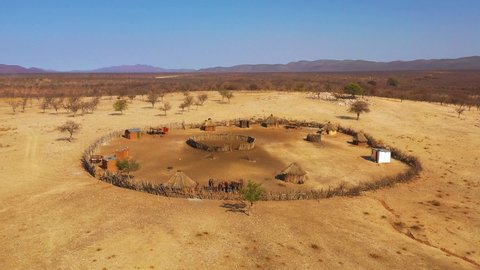 NAMIBIA - CIRCA 2018 - Beautiful aerial over a round Himba African tribal settlement and family compound in northern Namibia, Africa.