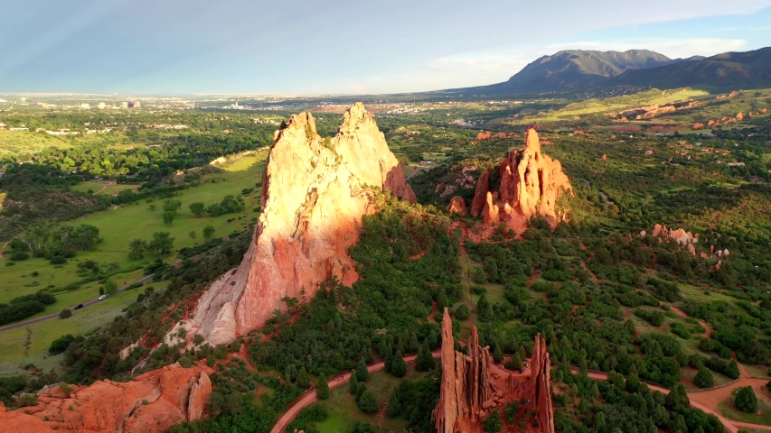 Aerial, drone shot, over the rocky red sandstone mountains, at Garden of the Gods park, on a sunny evening, in Colorado springs, USA