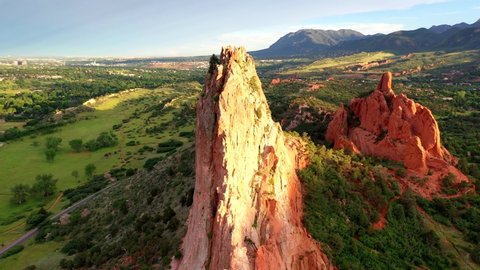 Aerial, drone shot, panning around the famous, red sandstone mountains, at the Garden of the Gods park, on a sunny evening, in Colorado springs, USA