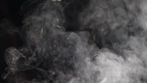 Closeup of white smoke in slow motion on black background. hd