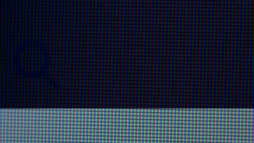 Writing code and hacking a system. Extreme macro of computer screen with code scrolling on it.