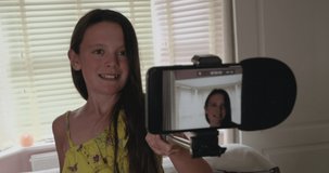 Preteen uploading her vlog live to her online video channel