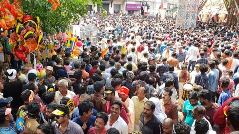 KERALA, INDIA - MAY 13, 2019: Huge crowd of people, tourist enjoying watching Thrissur Pooram festival or Puram, parade in Hindu temple with many decorated elephants with gold caparison, red umbrella.