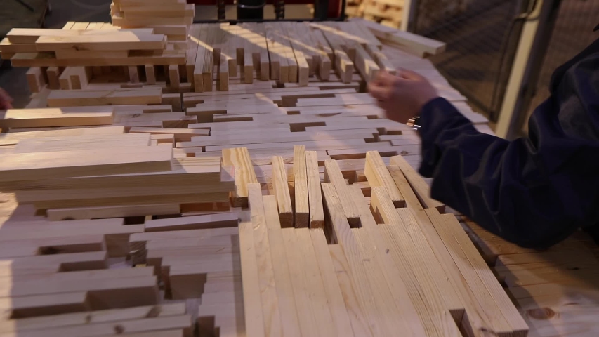 A woman works with her hands in a factory. Women work in a furniture factory, workflow in a furniture factory, sorting furniture bar