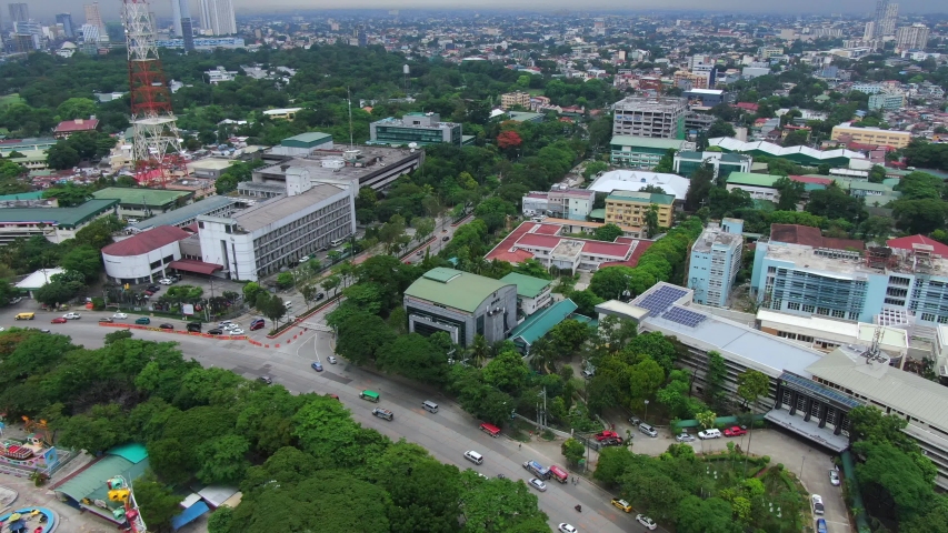 Nice aerial view following the vehicles at the round highway surround the Quezon Memorial Circle.