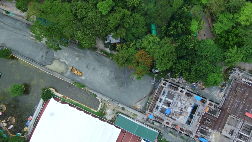 Top down aerial view of the nice green park and children playground at Quezon Memorial Park Philippines