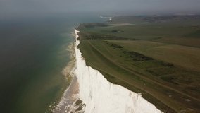 Descending drone footage over the white cliffs on the English South Coast on a beautiful spring day