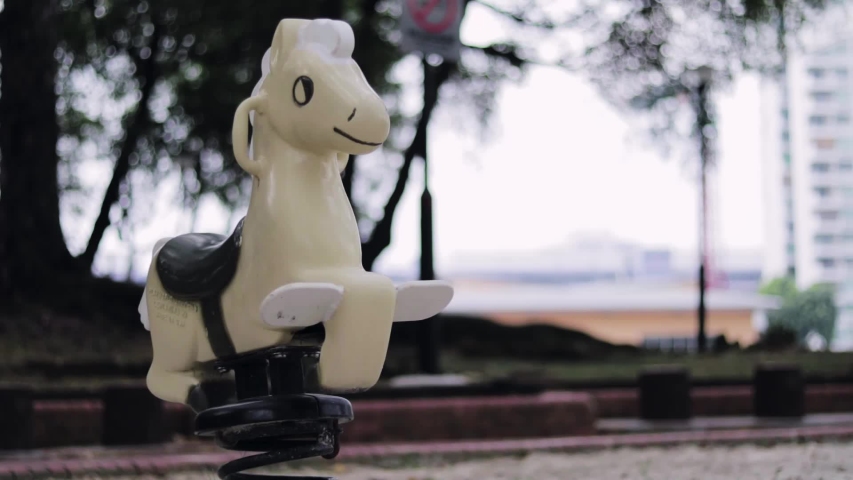 horse playground equipment for children in the park moving nobody with park background fun cheerful