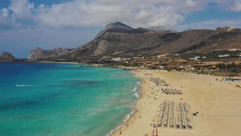 Aerial drone video of Falassarna beach, crystal waters, golden sand, endless sandy turquoise beach of Falassarna in Crete island, Greece. Famous Falasarna (also known as Falassarna or Phalasarna).