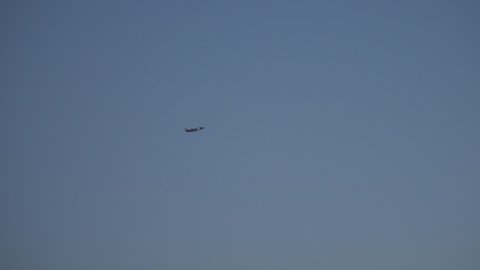 Aircraft is flying in blue sky after sunset
