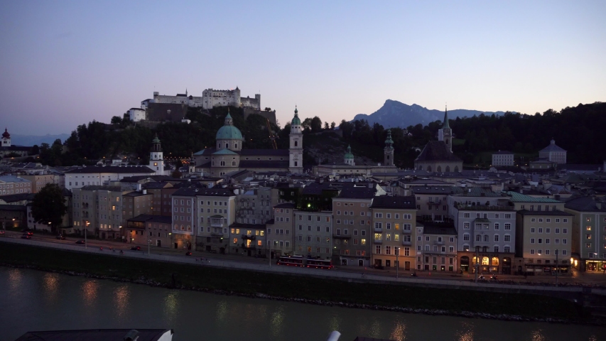 Salzburg baroque skyline at dusk with the mountains of the alps in the background viewed from the Kapuzinerberg. Austria
