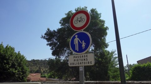 JOUQUES, FRANCE - CIRCA July 2019: "Mandatory pedestrian crossing" - "Passage pietons obligatoire" sign in France. Cars passing by