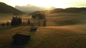 Aerial video of the sunrise in the Dolomites mountains. It was shot on the beautiful meadows of Seiser Alm plateau.