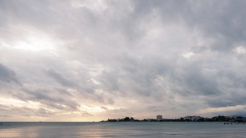 4k Timelapse video at the beach with mesmerizing clouds moving in the sky close to sunset at Anse Vata Bay in Noumea, New Caledonia - French Polynesia, South Pacific.