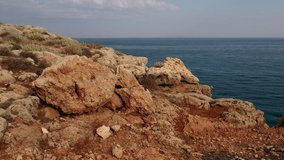 Aerial video view from lifting up drone on stone arch Kamara and coastal rocks near Geropotamos beach on Crete, Greece, Rethymno prefecture.