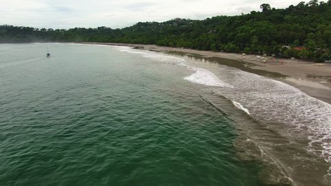 Wild tropical sand beach in rain season, aerial view, drone flying over a beach in Costa Rica