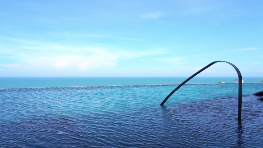 A serene swimming pool with a nice oceanic view.