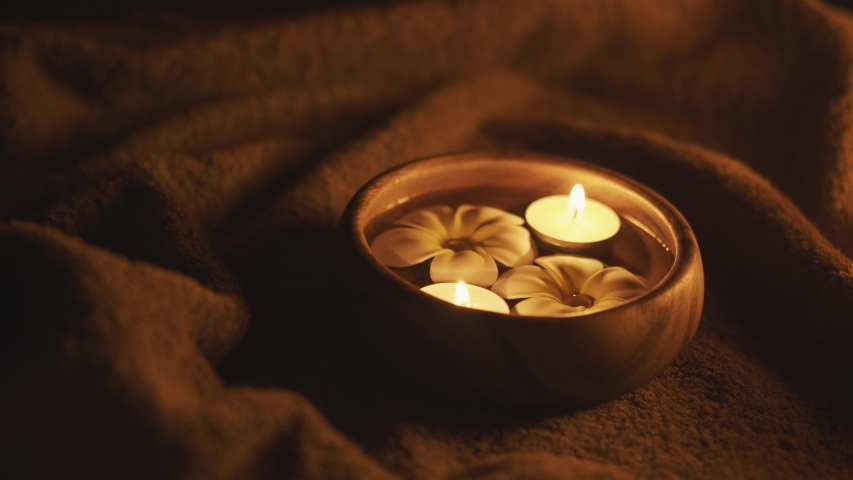 Thai massage spa ritual. Bali life style. Prayer ceremony. Ayurveda medicine. Hands put aroma bowl with oil.  Floating candles and frangapani flower in water. Couple practice. Relaxing therapy.  Royalty-Free Stock Footage #1035576665