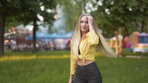 Blond attractive woman dances in outdoor festival alone