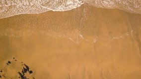 Drone footage of sea waves on the beach.