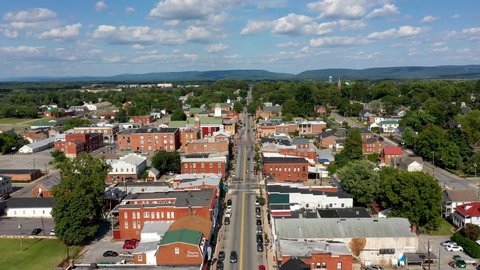 Aerial flyover main street toward the Jefferson County courthouse in Charles Town, West Virginia on a beautiful sunny day.