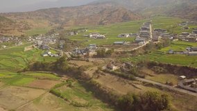 Aerial view of village in a valley next to a river in China, 4K