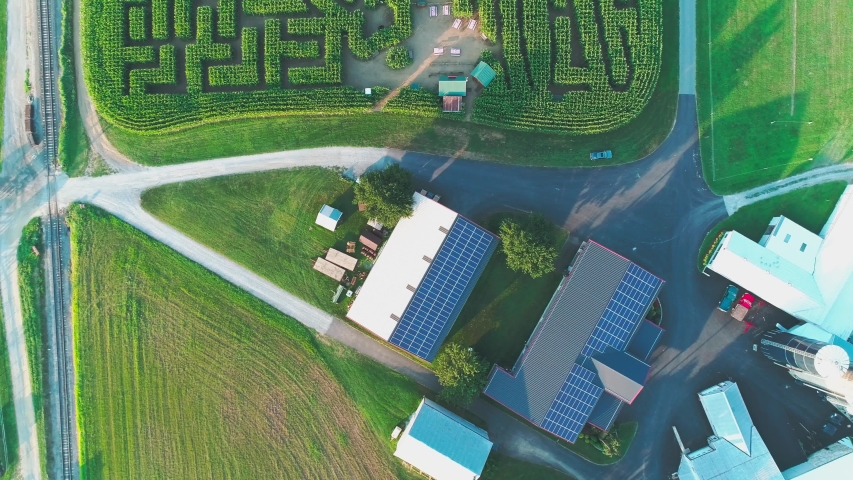 Aerial View of Amish Countryside with a Corn Maze in Late Afternoon with a Down Angle Shot on a Sunny Summer Day
