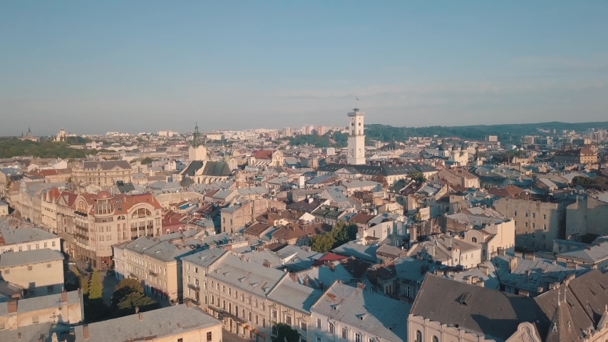 Aerial roofs and streets Old City Lviv, Ukraine. Central part of old european city in morning time. Panorama of the ancient town. City Council, Town Hall, Ratush. Drone shot | Shutterstock HD Video #1035586085