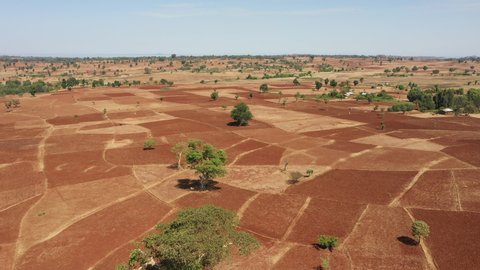 Aerial drone shot of beautiful red soil in rural region of Ethiopia, environmental and economic challenges in developing country East Africa
