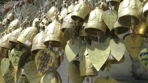 Phuket Town, Thailand - December 12, 2014: Copper bells with messages ring in the wind at the temple of the big white Buddha. Close up