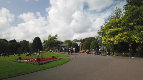 Glasgow, Scotland; August 17th 2019: The Botanic Gardens on Queen Margaret Drive on a beautiful sunny but windy day. People walking and sitting in the garden.