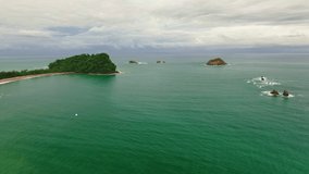 Romantic tropical beach and emerald green waters of the Pacific ocean, aerial view of the Costa Rica shoreline