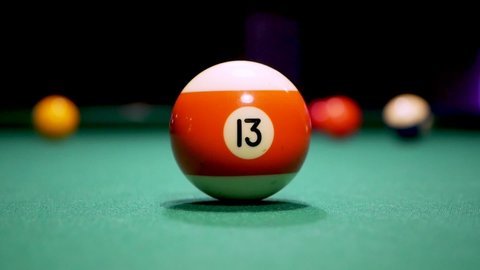 13 ball gets hit by white ball in a game of pool. Billiards