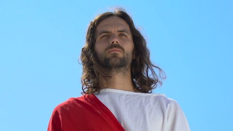 Blessed Jesus Christ impersonator raising hands to sky, praying father, asking God for mercy