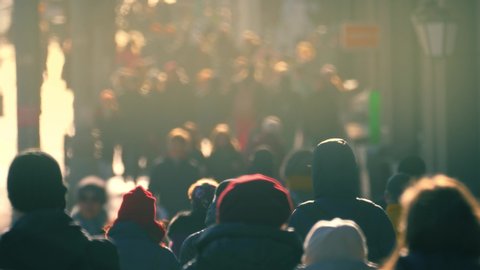 Crowd of unrecognizable people walking down on crowded city street. Slow motion, 4K UHD.	
