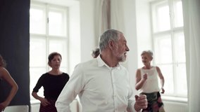 Group of senior people in dancing class with dance teacher. Slow motion. - Powered by Shutterstock - Get 15% off with code: PIKWIZARD15