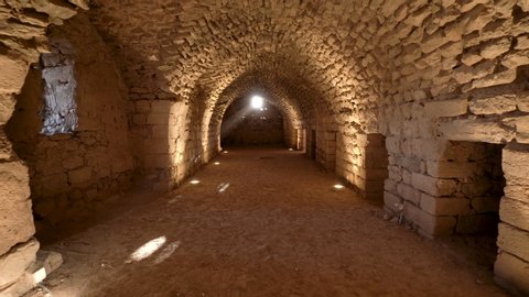 Karak / Jordan - 01 06 2019: Karak, Jordan, January 2019 - Walking on the Long Path of Stone Walls Cellar with Arch Ceiling Under the Ruins of Kerak Crusaders Castle