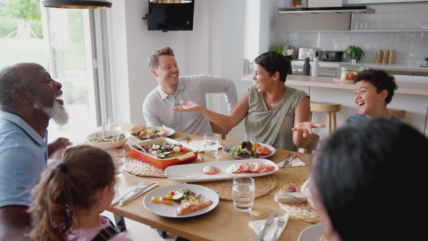 Multi-Generation Mixed Race Family Eating Meal Around Table At Home Together Royalty-Free Stock Footage #1035638111
