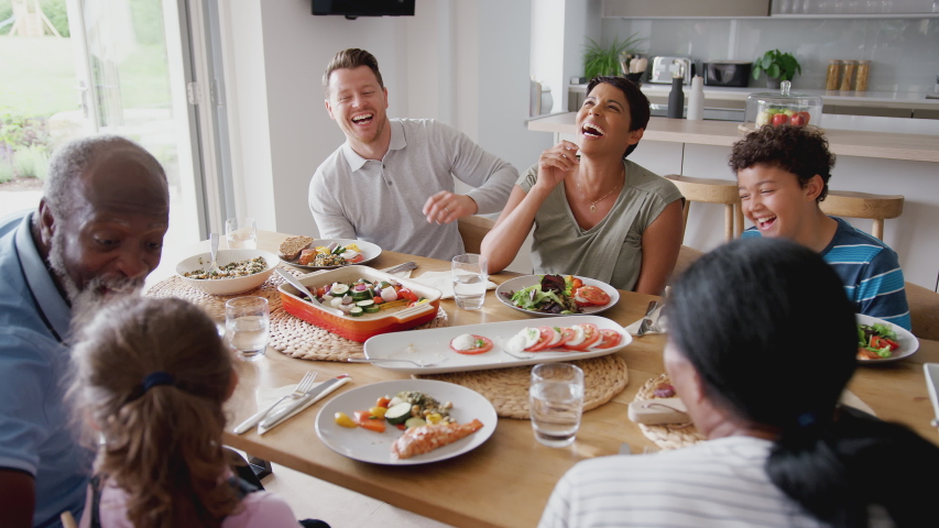 Multi-Generation Mixed Race Family Eating Meal Around Table At Home Together | Shutterstock HD Video #1035638111