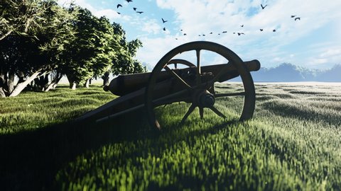 Medieval Cannon in a field in the middle of green grass at sunrise before the battle.