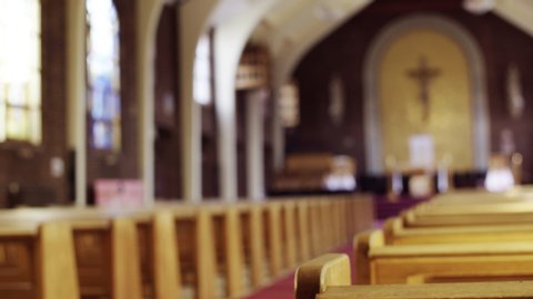 Sliding shot of Pews in Church with a shallow DOF