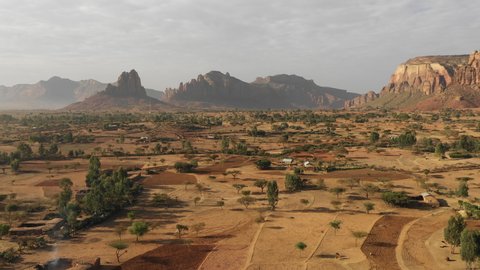 Africa desert landscapes - drone flight of rural fields and small village community in surreal mountain setting, agriculture and scenery in Tigray region in Ethiopia